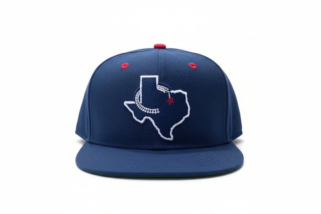 A navy blue fitted hat with a white Texas logo and a red dot on the brim.